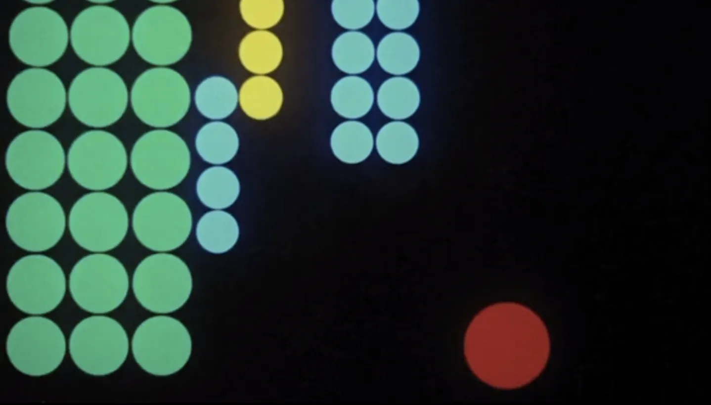 Abstract grid of glowing coloured circles on a black background in green, yellow, cyan, and red
