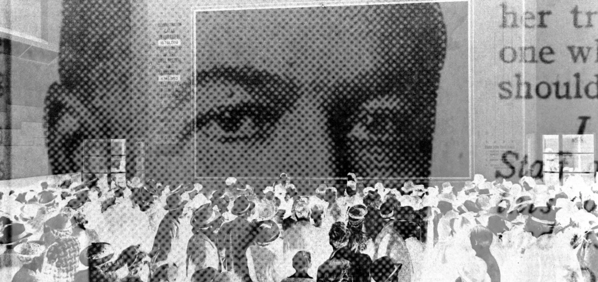 Black and white composed image of a man looking over a crowd