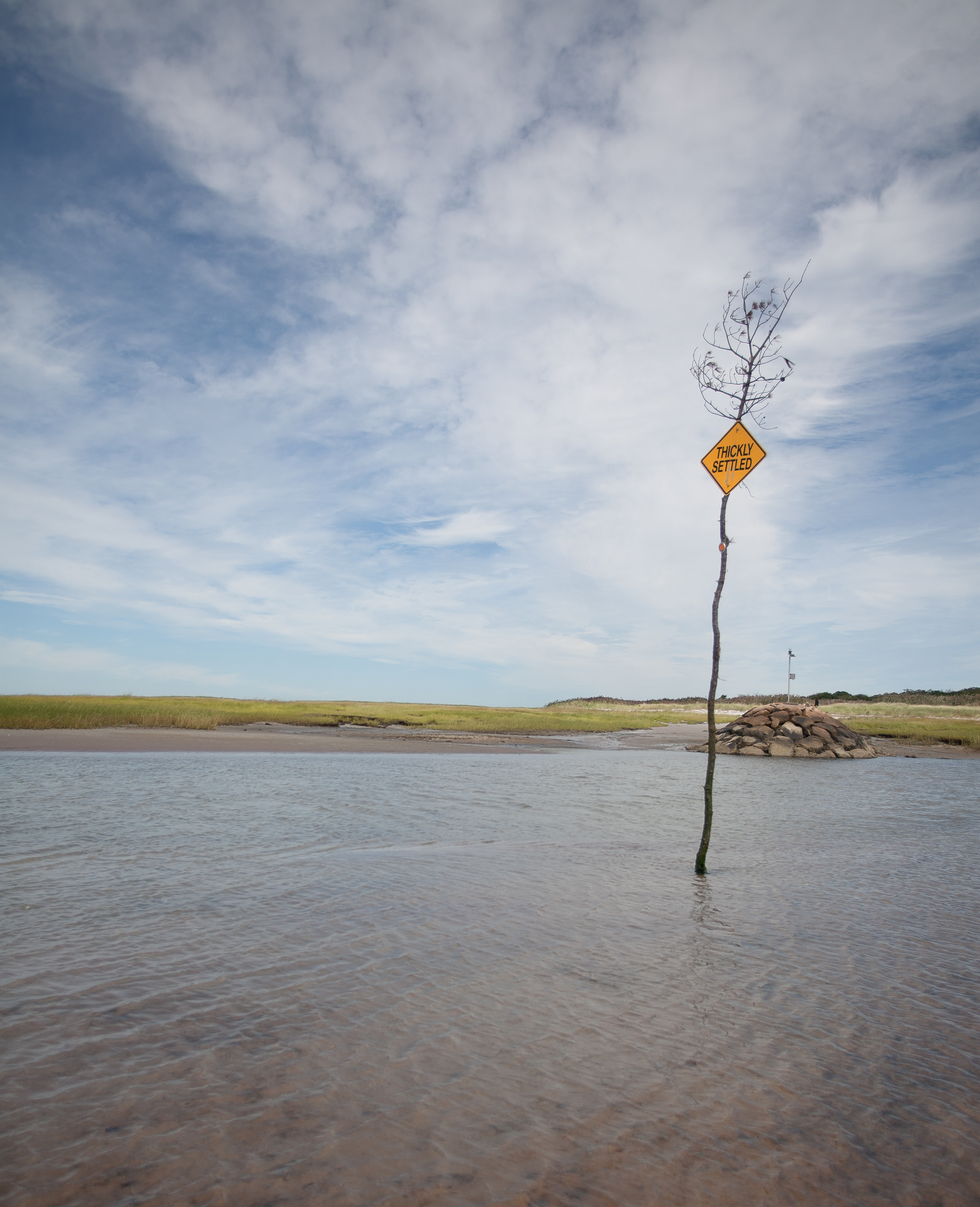 Thickly settled sign in tidal flat